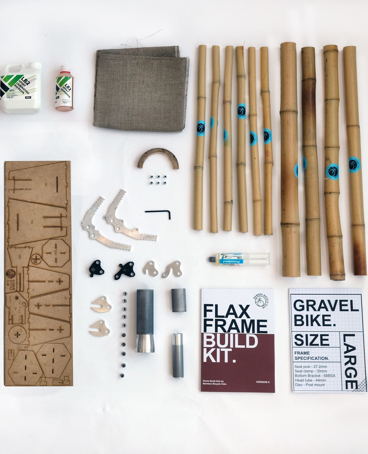 Bamboo tubes, flax cloth, resin, MDF jig parts and metal fittings on white: the flax gravel frame kit