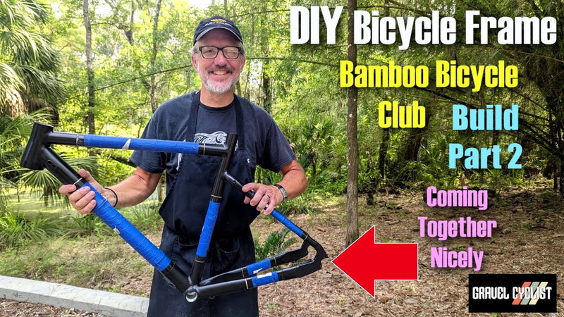 Gravel Cyclist video thumbnail: a builder holds up a blue-taped frame under the title 'DIY Bicycle Frame'