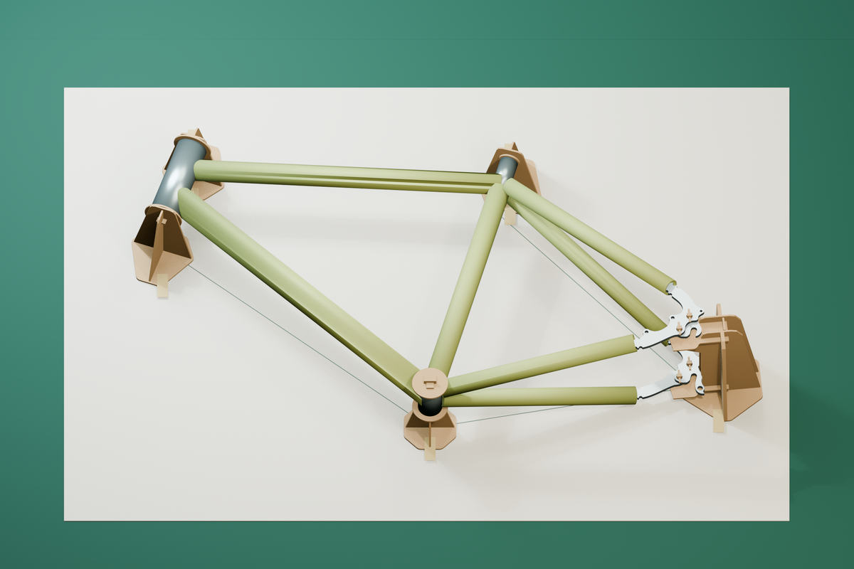 CAD rendering of the five MDF jig holders supporting an illustrative frame on a full-size plan, with tape securing the bases.