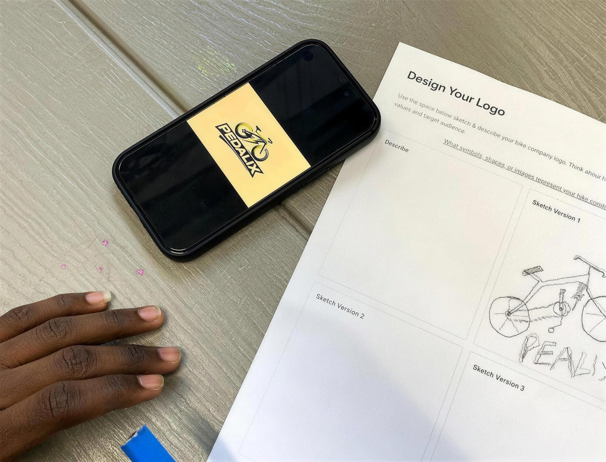A phone and a design-your-logo worksheet
