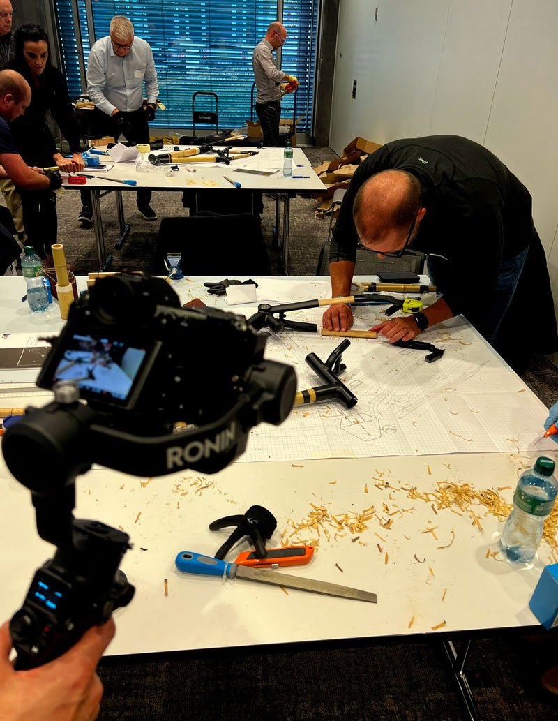 A corporate team building bamboo bike frames together