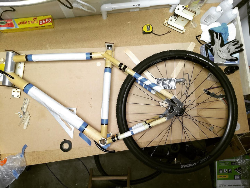 Adam checking wheel clearance on a home build gravel bike. The rear triangle can be difficult to bui
