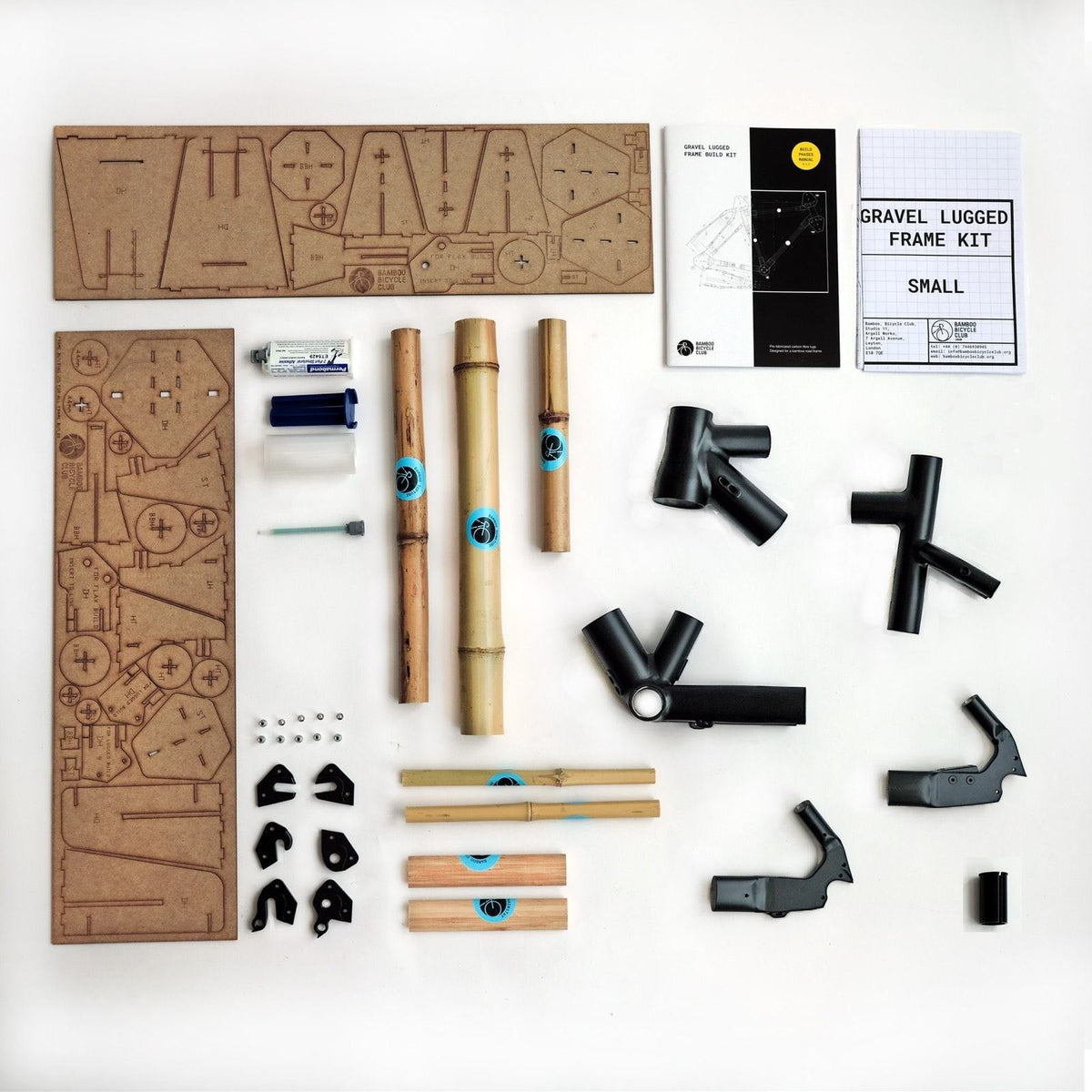 A bamboo frame kit laid out flat — tubes, lugs, dropouts and plans