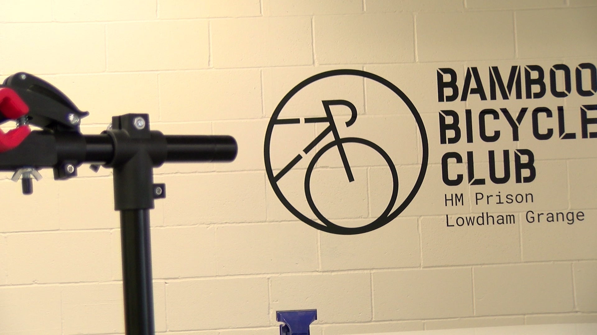The Bamboo Bicycle Club roundel painted on the workshop wall at HMP Lowdham Grange
