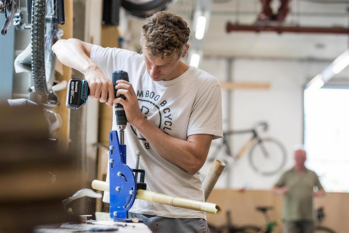 James Marr drilling bamboo in a workshop jig.