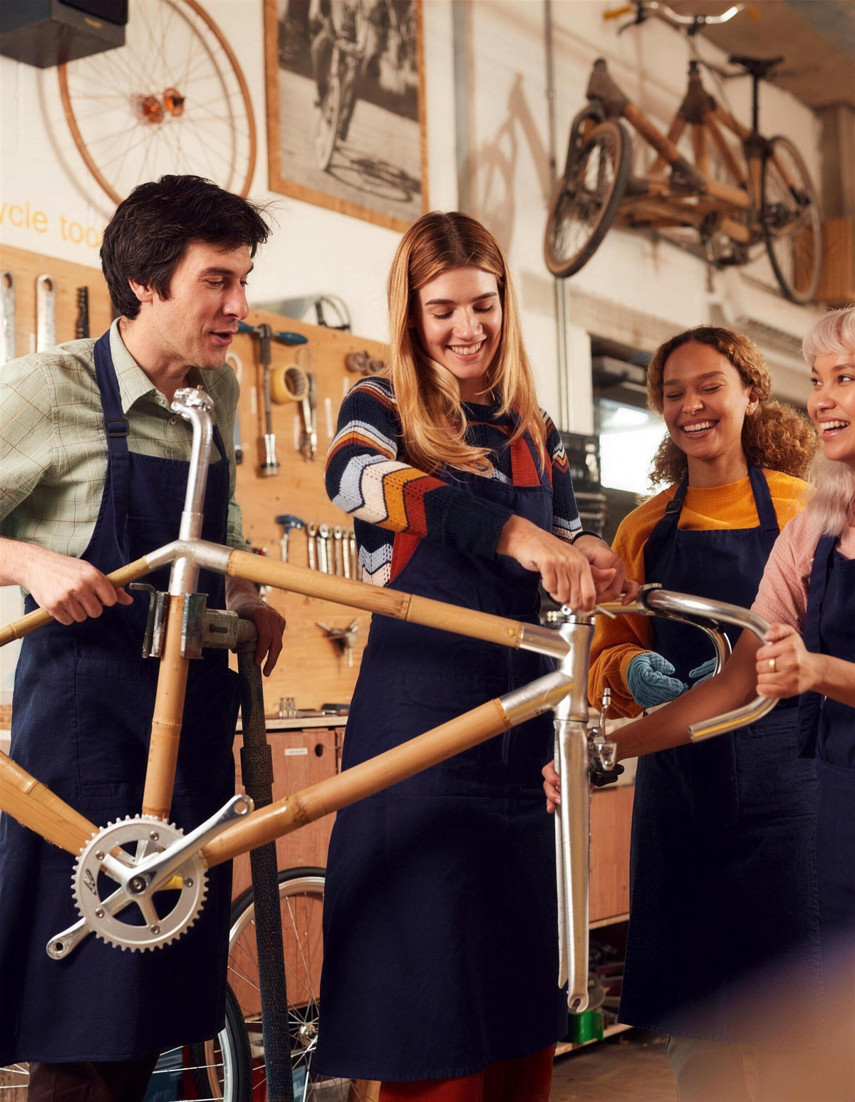 Four people assembling a bamboo road bike frame together in our workshop