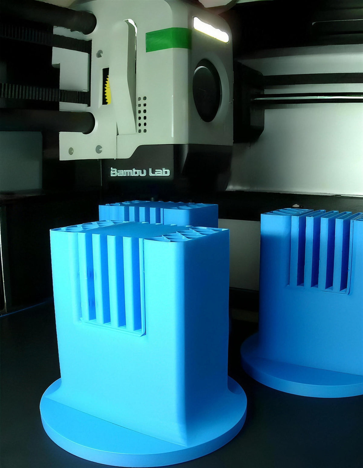 Inside our Bambu Lab 3D printer: the toolhead printing two blue parts