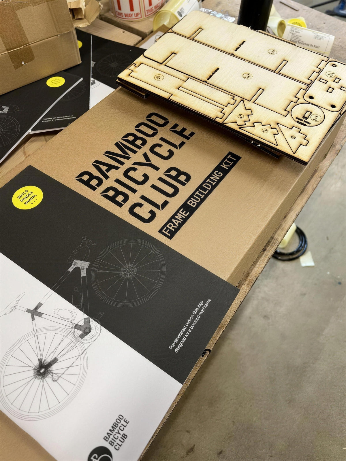 Our printed Frame Building Kit box, with the laser-cut jig and the build manual on top.