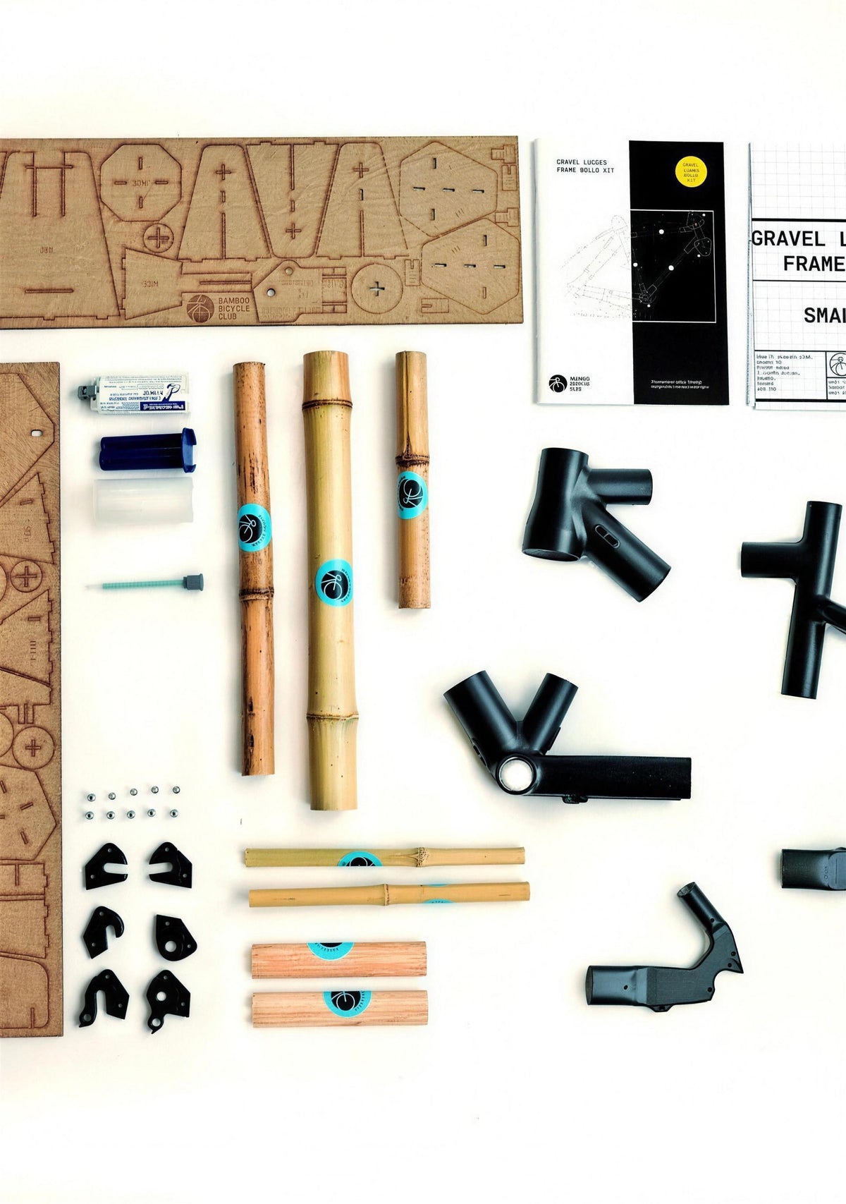 Our Gravel Lugged frame kit laid out: laser-cut jig, bamboo tubes, frame lugs, dropouts, adhesive, the build manual and the frame specification.