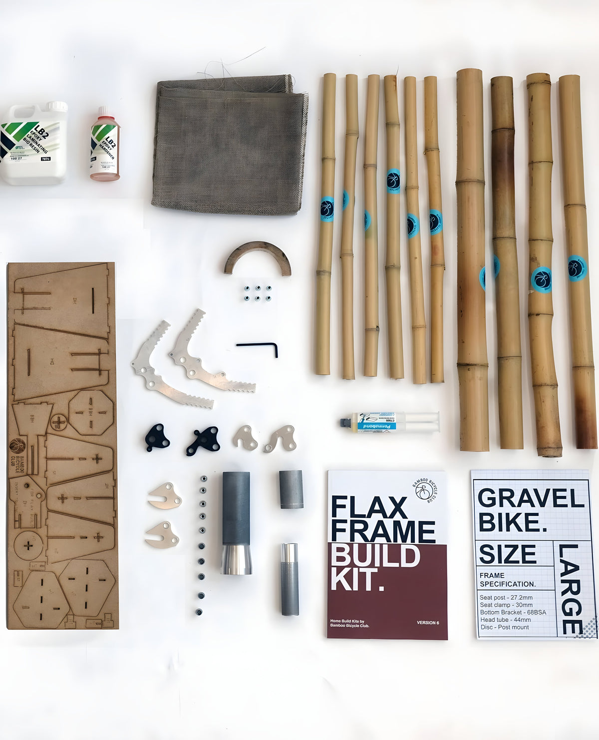 A bamboo frame kit laid out: tubes, lugs, dropouts and the build manual