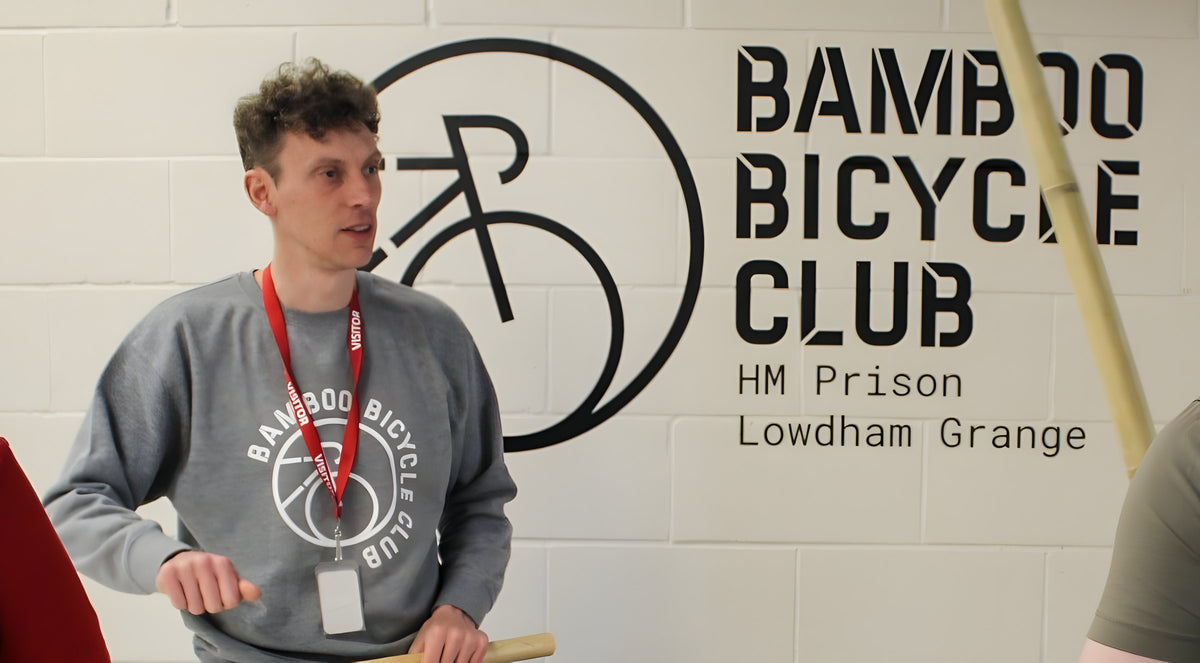 James Marr, our founder, at our workshop sign in HMP Lowdham Grange, holding bamboo. No one from the prison is shown.
