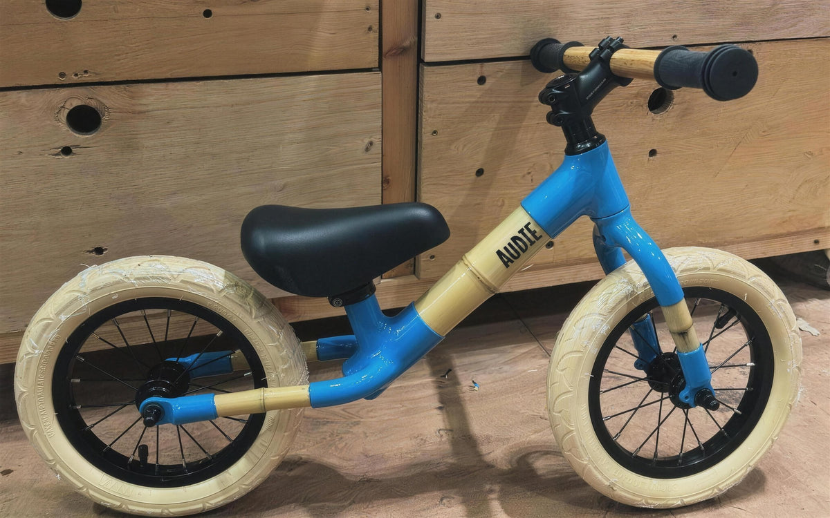 A blue bamboo balance bike