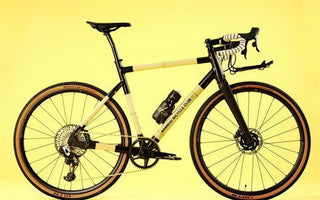 A Bamboo Bicycle Club gravel bike photographed on a yellow studio background