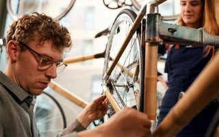 A man working on a bike frame in our workshop
