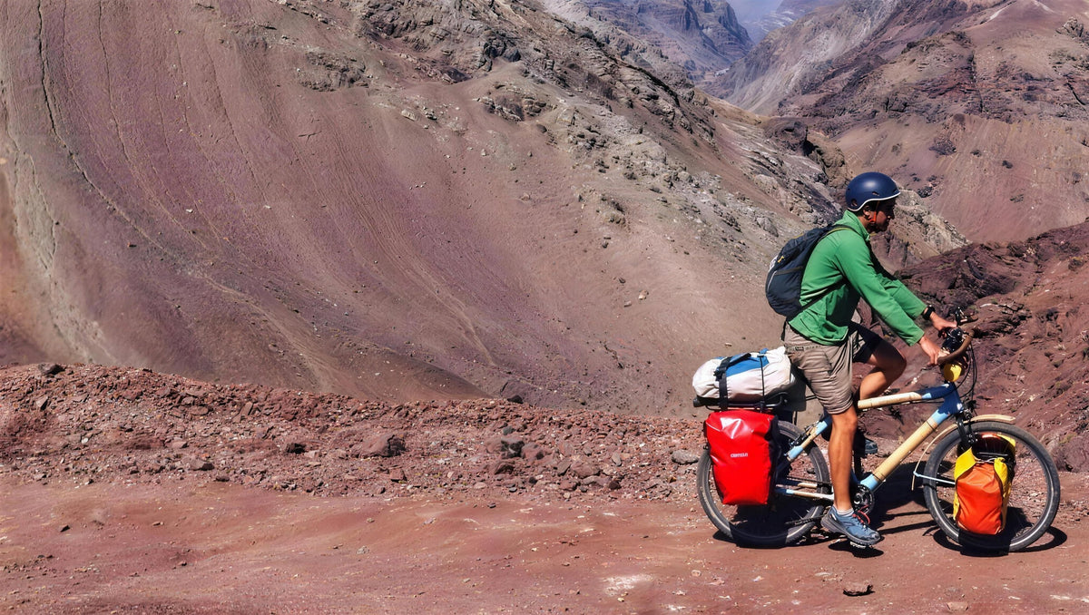 A loaded bamboo touring bike on a mountain track