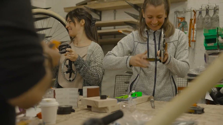 A corporate team building bamboo bikes together